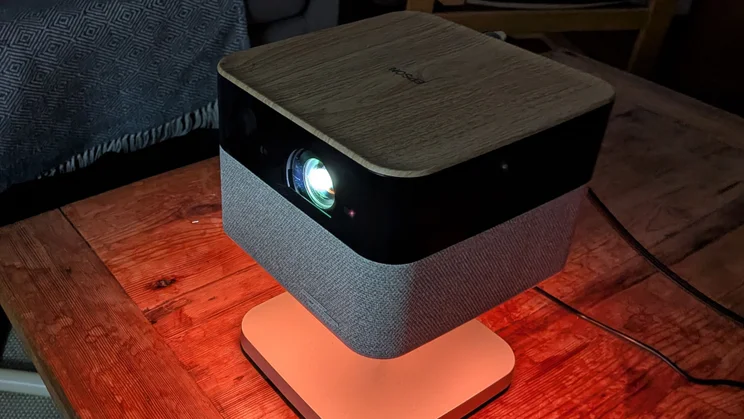 The Epson Lifestudio Flex EF-72 4K projector beaming an image in a dark room setting