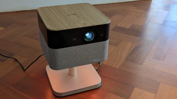 The Epson Lifestudio Flex EF-72 4K projector on a wooden floor pointing forwards