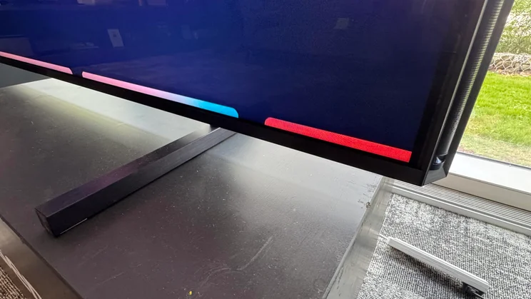 Close-up of the right foot stand of the Hisense 116UX RGB Mini LED TV