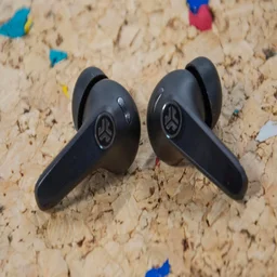 The JLab JBuds Pods ANC wireless earbuds on a cork table