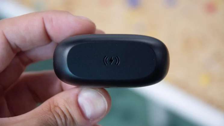 The underside of the JLab JBuds Pods ANC wireless earbuds' charging case, showing the wireless charging symbol