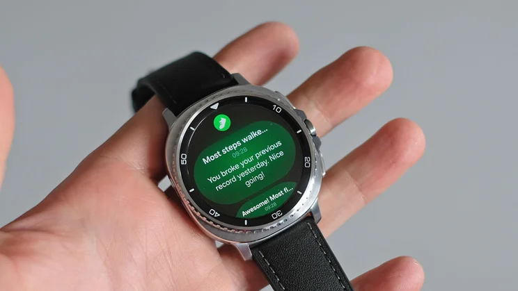 The Samsung Galaxy Watch 8 Classic being held in a person's hand and displaying the number of steps walked