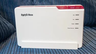 The AVM Fritz!Box5690-Pro pictured from the front on a blue sofa