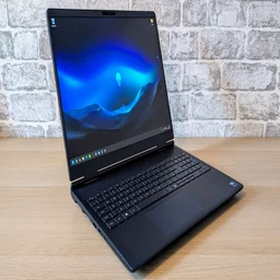 Alienware 16X Aurora - open on a pale wood desk