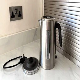 The Breville Edge Low Steam kettle on a kitchen worktop, alongside its base
