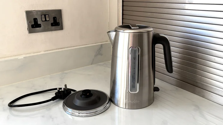The Breville Edge Low Steam kettle on a kitchen worktop, alongside its base