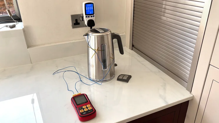 The Breville Edge Low Steam kettle on a kitchen worktop. A thermometer and temperature probes are being used to test the internal and external temperatures
