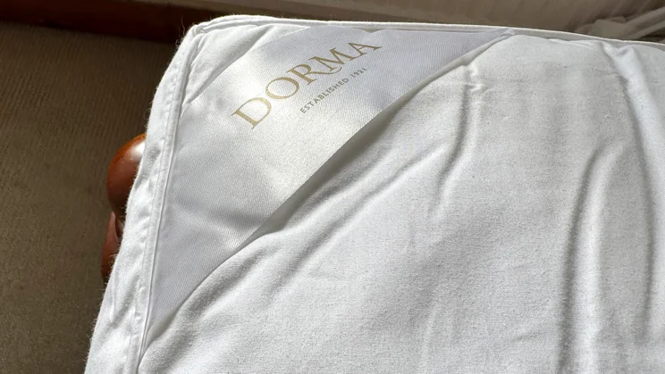 A closeup of the corner of the Dorma Full Forever mattress topper, showing the Dorma brand label