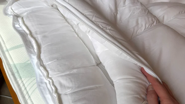 A closeup of the Dreams Dream Team Ultimate Washable Mattress Topper. The two layers have been unzipped and separated