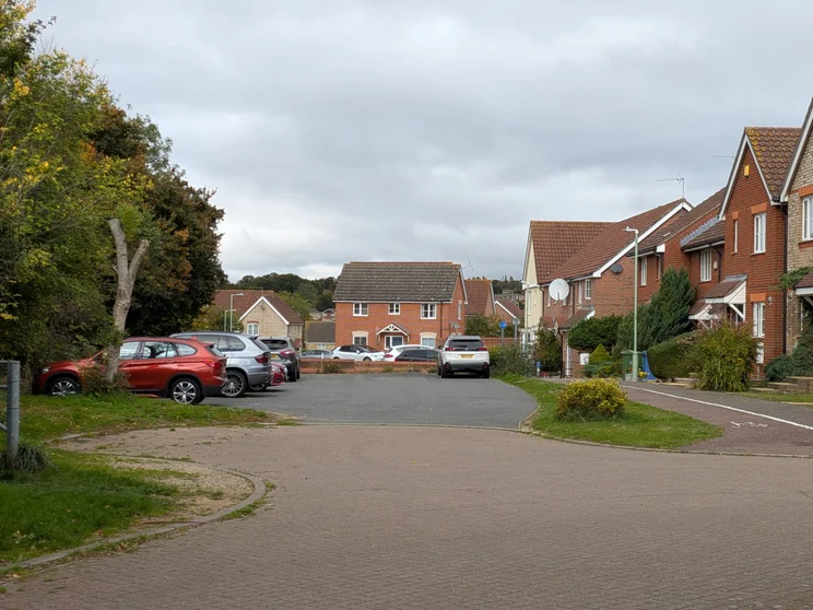 2x zoom of houses with cars parked out front