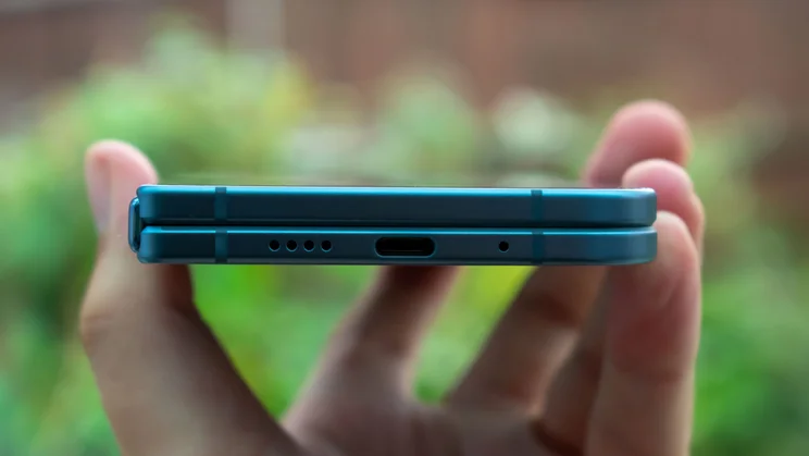 Google Pixel 10 Pro Fold folded in hand, bottom edge view