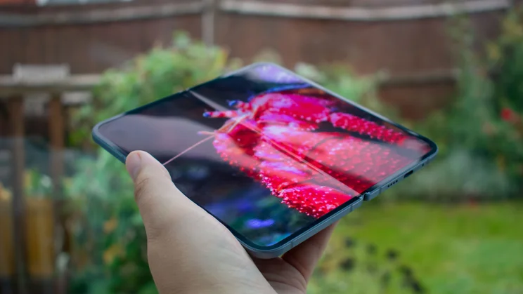 Google Pixel 10 Pro Fold unfolded in hand, angled view