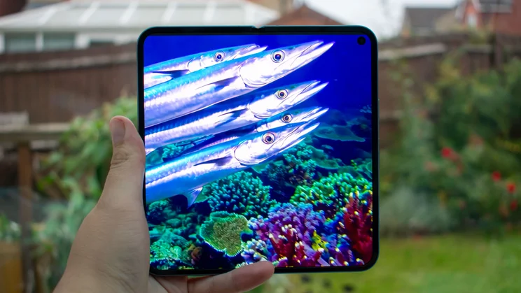 Google Pixel 10 Pro Fold unfolded in hand, with a video on the display