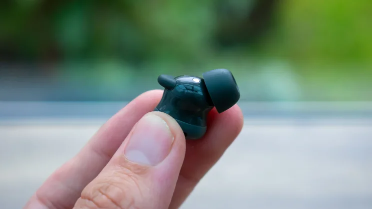Hand holding a Google earbud, showing the stabilisation fin