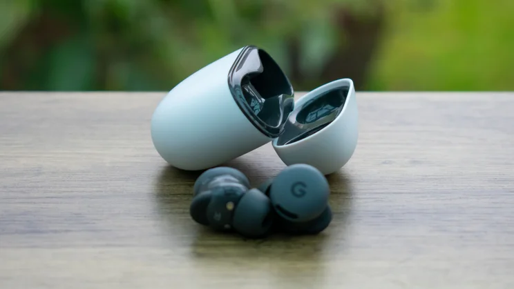 Google Pixel Buds 2a charging case with buds in front of it
