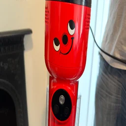 A closeup of the Henry face logo on the main body of the Henry Quick Corded vacuum cleaner