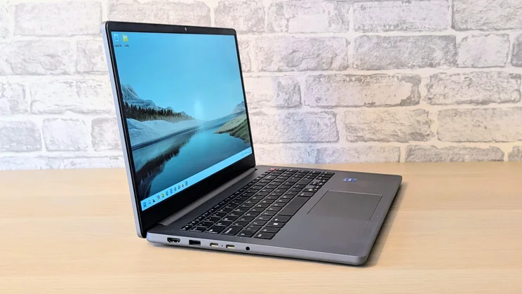 LG Gram Book AI, open on a wood desk, facing right in the frame