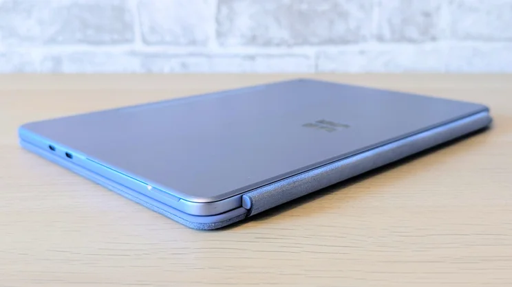 Microsoft Surface Pro 12-inch pictured, with keyboard case, closed on a wood desk