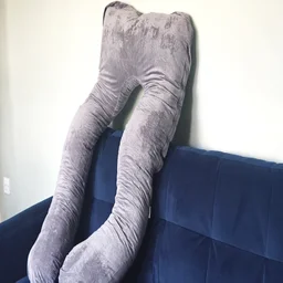 The Nuliie Pregnancy Pillow upright on a sofa