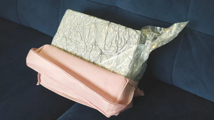 The Nuliie Pregnancy Pillow vacuumed packed and in its pink case