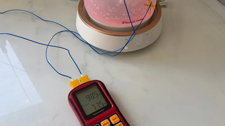 A thermometer measuring the internal and external temperature of the Russell Hobbs Calm Kettle. The kettle is glowing pink