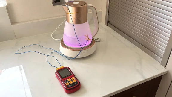 A thermometer measuring the internal and external temperature of the Russell Hobbs Calm Kettle. The kettle is glowing pink
