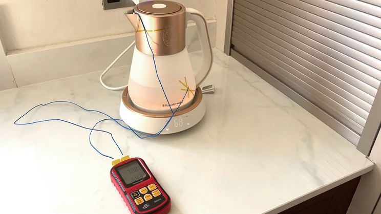 A thermometer measuring the internal and external temperature of the Russell Hobbs Calm Kettle. The kettle is glowing orange