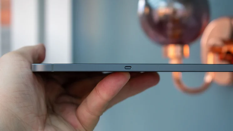 Hand holding the Samsung Galaxy Tab S11, showing the edge