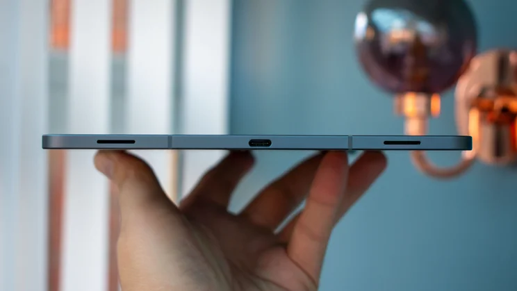 Hand holding Samsung Galaxy Tab S11, showing the charging port