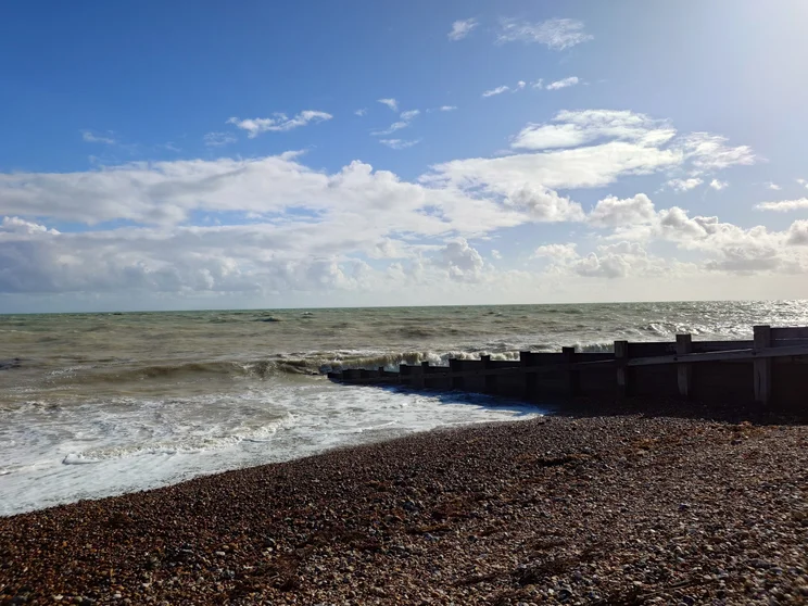 A beach with the tide coming in