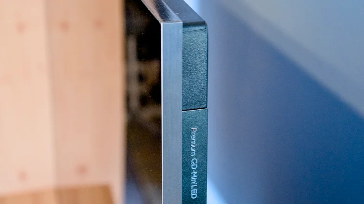A photograph showing how thin the TCL C7K is, from the top right edge
