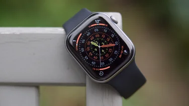 The Apple Watch Series 11 from the front, hung on a garden chair