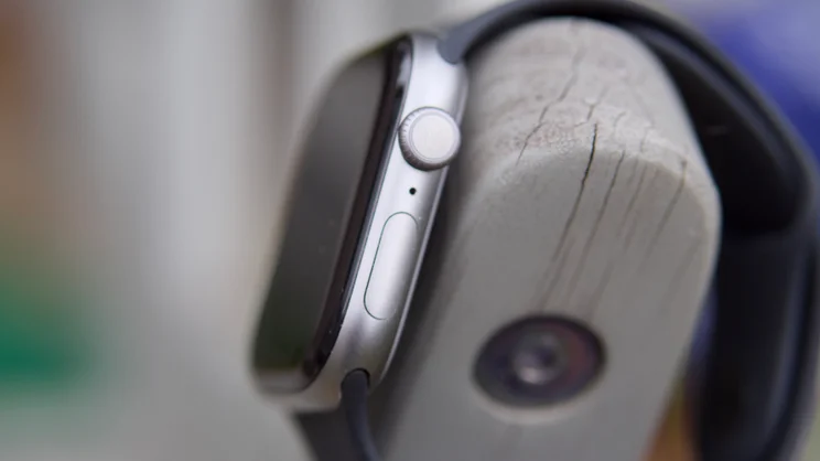 The right edge of the Apple Watch Series 11, hung on a garden chair