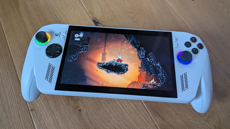 The Asus ROG Xbox Ally gaming handheld displaying gameplay from Hollow Knight: Silksong
