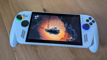 The Asus ROG Xbox Ally gaming handheld displaying gameplay from Hollow Knight: Silksong