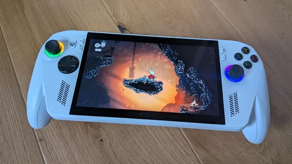 The Asus ROG Xbox Ally gaming handheld displaying gameplay from Hollow Knight: Silksong