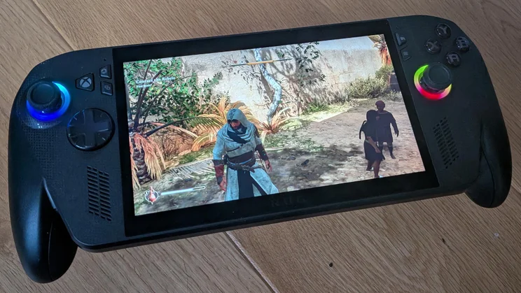 The Asus ROG Xbox Ally X gaming handheld displaying gameplay from Ubisoft game Assassin's Creed Mirage