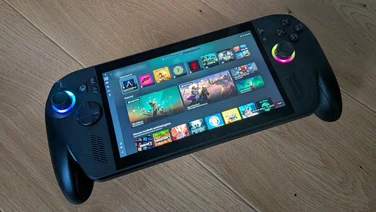 The Asus ROG Xbox Ally X gaming handheld on a wooden table