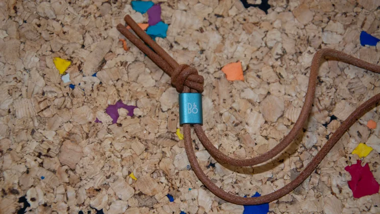 Close-up of the B&O toggle on the leather strap of the Bang & Olufsen A1 3rd Gen Bluetooth speaker