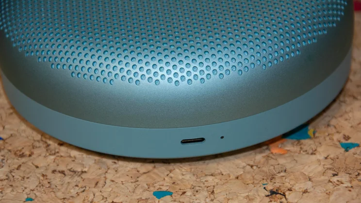 Close-up of the USB-C charging port on the side of the Bang & Olufsen A1 3rd Gen Bluetooth speaker