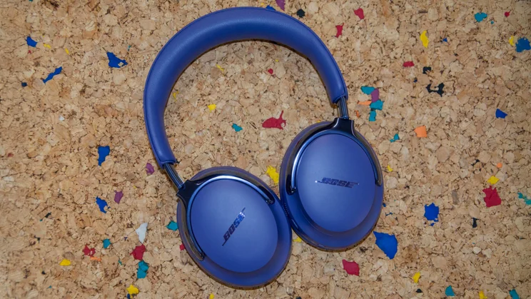 Top-down view of the Bose QuietComfort Ultra Headphones (2nd Gen) lying flat on a cork table