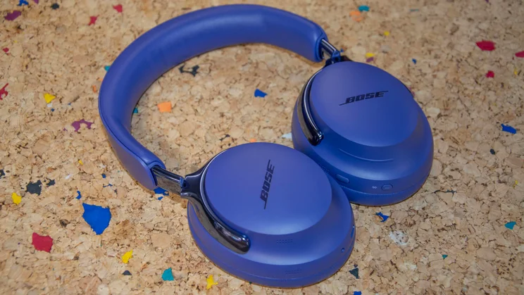 Angled view of the Bose QuietComfort Ultra Headphones (2nd Gen) lying flat on a cork table