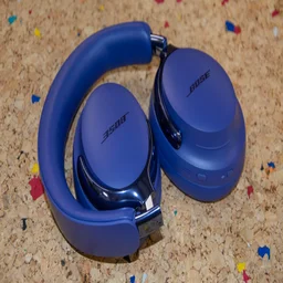 The Bose QuietComfort Ultra Headphones (2nd Gen) folded up on a cork table