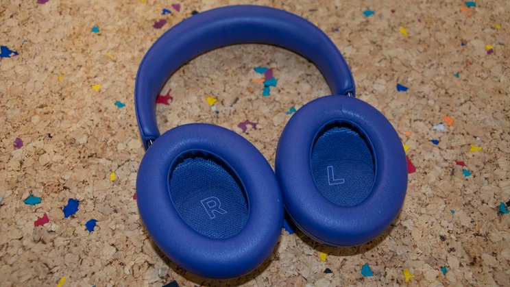 The Bose QuietComfort Ultra Headphones (2nd Gen) on a cork table with the inside of their earcups facing upwards