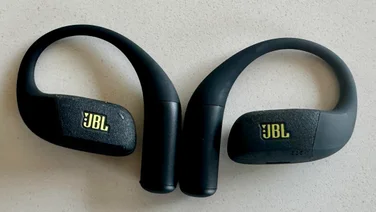 The JBL Endurance Zone open-ear headphones side-by-side on a white table