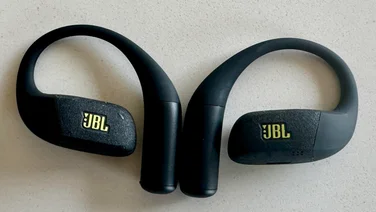 The JBL Endurance Zone open-ear headphones side-by-side on a white table
