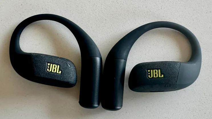 The JBL Endurance Zone open-ear headphones side-by-side on a white table