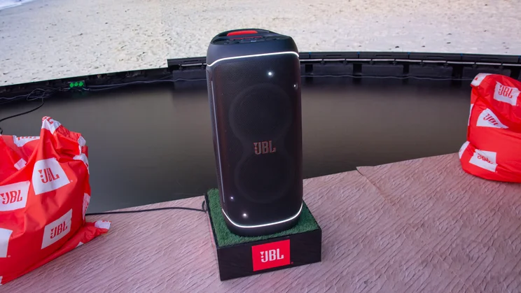 The JBL PartyBox 720 Bluetooth speaker between two large red beanbags