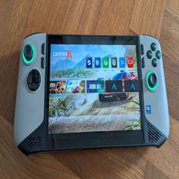 The MSI Claw 8 AI+ A2VM gaming handheld on a wooden table with the Center M interface on screen