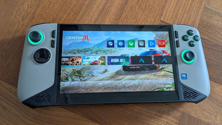 The MSI Claw 8 AI+ A2VM gaming handheld on a wooden table with the Center M interface on screen
